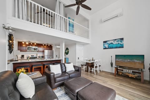 Spacious living room with high ceilings, a smart TV, and direct access to the lanai.