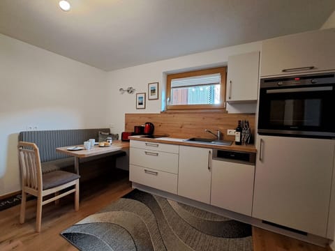 Furniture, Flooring, Interior Design, Wood, Floor, Countertop, Cabinetry, Kitchen, Room, Kitchen Appliance