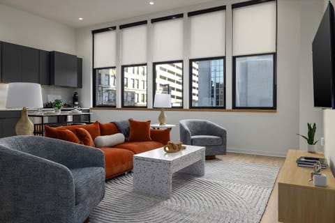  Entertainment and productivity combine in this sleek living area with city views. → Ready to stay here? Message us now!