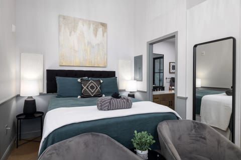 Cozy seating at the foot of the cozy bed and a full length mirror to check out your OOTD 
