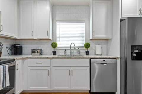 The kitchen workspace is both functional and picturesque, making meal prep enjoyable with a glimpse of the outdoors.