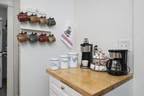 Enjoy a coffee station with tea, sugar, coffee, an instant coffee machine, and a coffee pot.