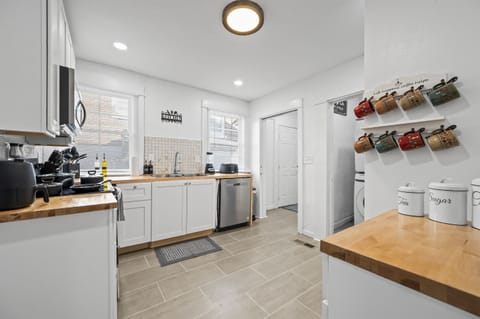 Kitchen transitions seamlessly into the hallway leading to the half bath and laundry room.