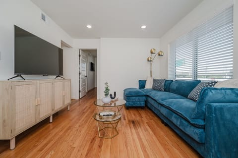 Light-filled living room with direct access to the balcony for an airy, open feel.