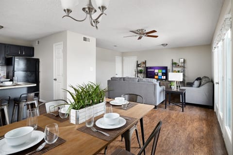 Dining area with stylish table décor and a view of the living room
