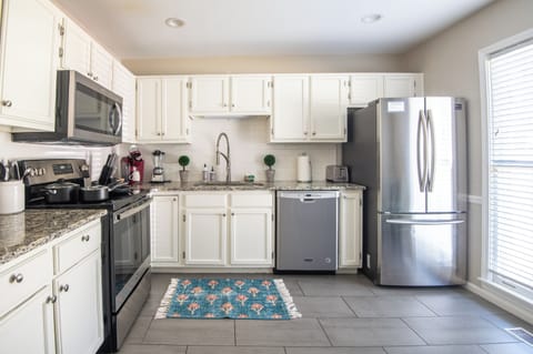 Fully equipped kitchen featuring stainless steel appliances, sleek countertops, and ample cabinet space.