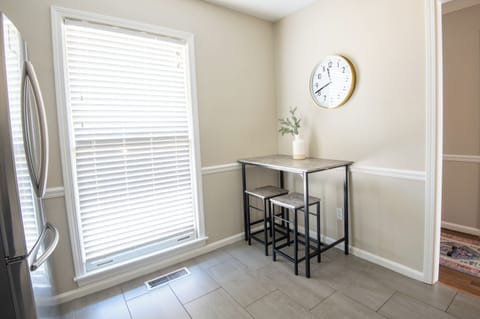 Fully equipped kitchen with a cozy dining area, modern finishes, and ample natural light.