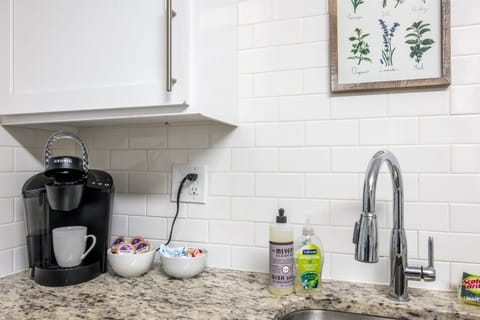 Coffee station and sink area with a Keurig, mugs, and hand soap—everything you need to start your day right.