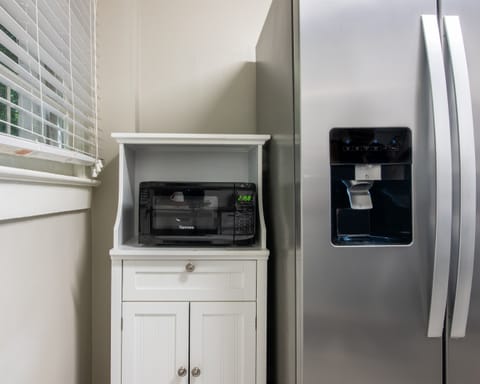 Modern kitchen essentials including a microwave and spacious fridge to store all your favorites.