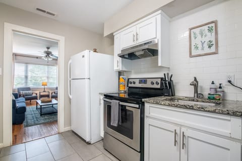 Another angle of the kitchen showing ample counter space and updated appliances.