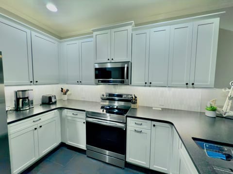 Stainless appliances and large dark granite countertops