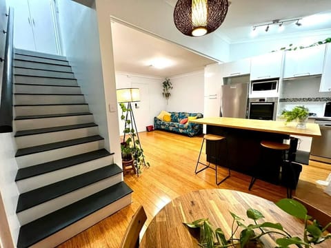 Living dining kitchen with stairwell leading to upper loft level