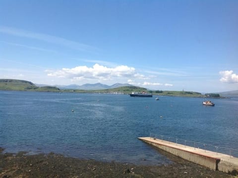 Stroll along the calm waterfront with scenic reflections nearby.