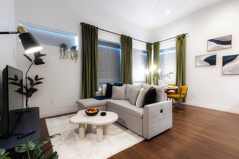 Living room with 50" Smart TV and slide out sleeper sofa w/ bedding.