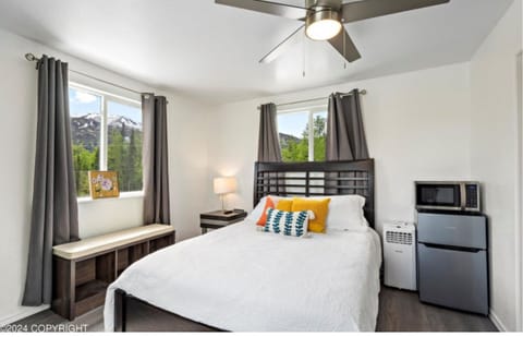 The apartment's interior features bed, window seat, mini fridge, and microwave.