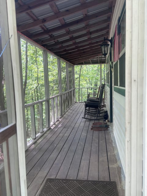 Screened in porch with rocking chairs for quiet relaxation