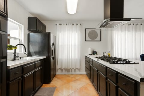 Kitchen with pots, pans, olive oil, salt, pepper and many more seasonings. 