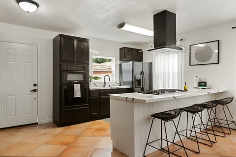 Kitchen with oven, stove, microwave, refrigerator, blender, toaster and more