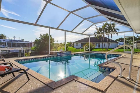 Screened pool area with canal views, perfect for relaxing sunny afternoons.