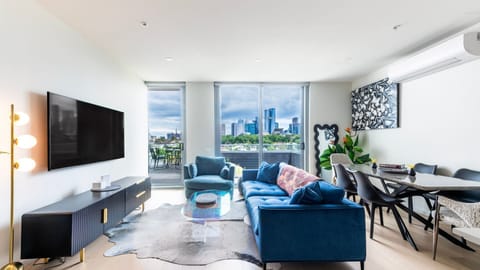 Bright and modern living area with floor-to-ceiling windows and city views.