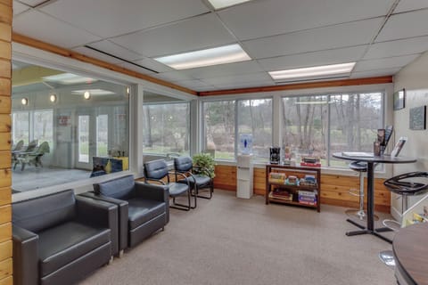 The community clubhouse offers games, social spaces, and mountain views through the sunroom.