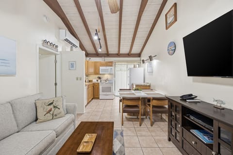 The kitchen is equipped with wood cabinetry, modern appliances, and ample counter space for preparing meals during your stay.