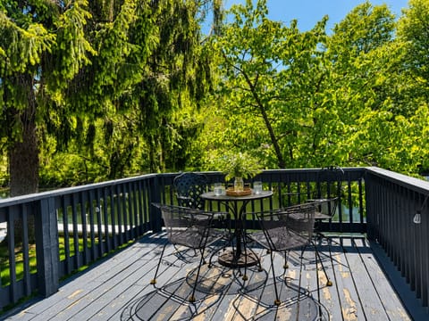 Deck with a table, perfect for enjoying meals or drinks.
