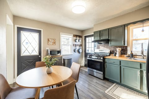 From this view, you’ll see our well-planned kitchen with a microwave stand, and a full set of pots, pans, and utensils. Abundant windows fill the space with natural light, creating a bright and welcoming atmosphere for cooking and dining.