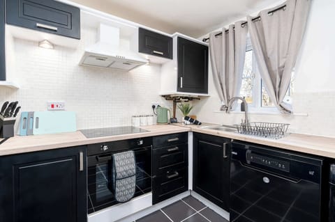 Fully equipped kitchen with ample counter space and all appliances needed for preparing quick meals between jobs or cooking proper dinners after work.