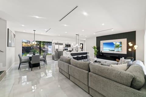 This elegant living room combines bright white walls with soft gray tones