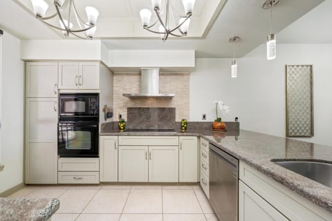 Well equipped kitchen with modern appliances and granite countertops
