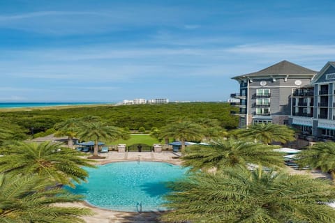 Breathtaking views of the azure pool with a lush tropical backdrop, steps from the beach.