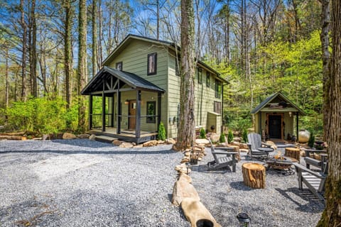 Charming green cabin nestled in nature, perfect for a relaxing getaway.