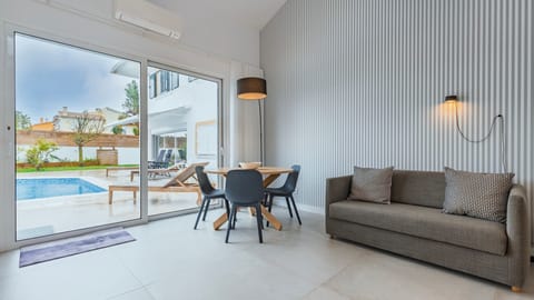 Bright, modern, and connected to the pool terrace, this inviting living space is perfect for relaxing, dining, and making the most of indoor-outdoor living. #ModernLiving #PoolView #HolidayHome #FamilyStay #Portugal #PT #Aroeira #Marisol