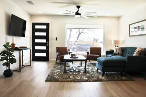 Living Room with Ceiling Fans and shades on all windows to allow for privacy