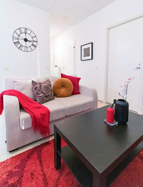 Romantic red accents in the living room set the perfect mood.