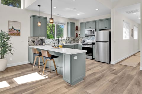 Beautiful kitchen with a peninsula island and seating for two. (1)