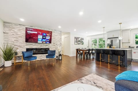 MainLevel Open Concept: Living Room with 75" Smart TV & Garage access