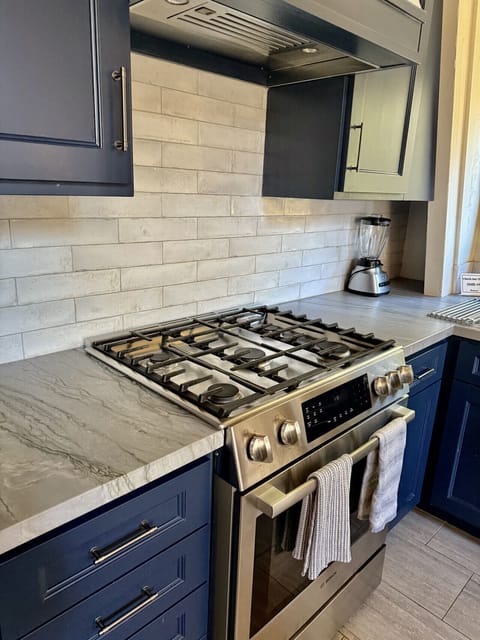 Well appointed kitchen with 5 burner gas stove.