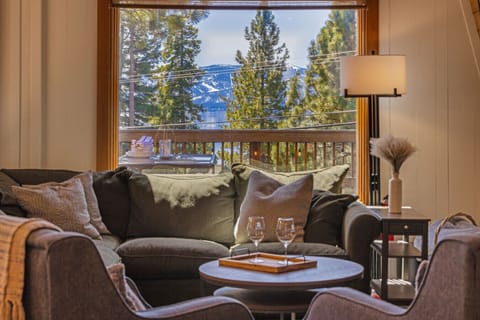 Living Room: Stunning space with vaulted ceilings, ample light, and breathtaking lake views!