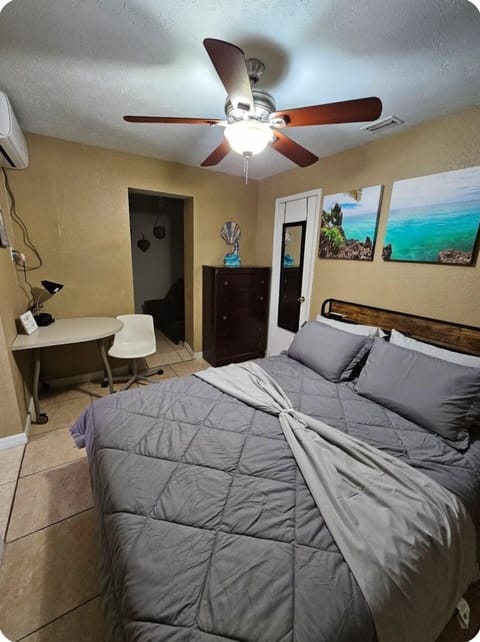 Queen size bed, small work desk space.