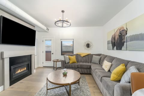 Open Living Area with TV, Gas Fireplace, & Balcony access | Main Level