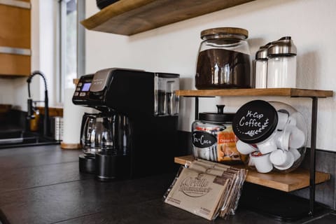 Coffee bar set up with ground coffee, k cups, sugar, power creamer, tea, coco and microwave popcorn for movie night.
