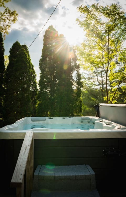 Sink into the warm bubbles as the sun peeks through the trees - pure lakefront serenity from your private hot tub.
