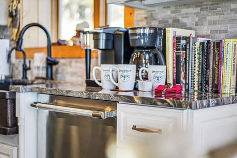 Your fully equipped kitchen features granite counters, coffee station, and cookbook collection for memorable culinary adventures.