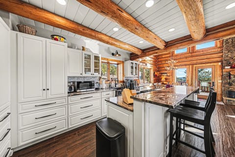 Cook in your rustic-chic kitchen featuring exposed beams, granite counters, and scenic mountain views through every window.