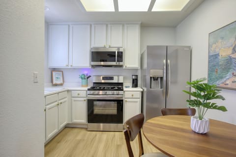 The fully equipped kitchen has a refrigerator, stove and oven, microwave, k-cup coffee maker, and dish ware—everything you need to whip up meals or enjoy a fresh cup of coffee before heading to the beach.