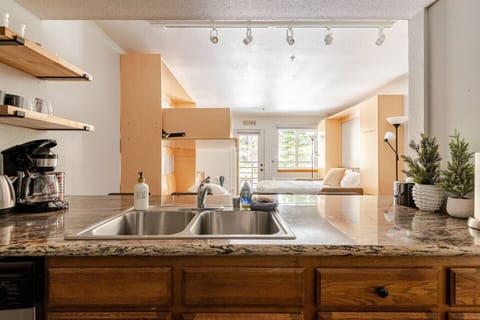 This open-layout kitchen offers efficient service for guests, with ample counter space for prep and easy access to dining and living areas—ideal for hosting or quick, convenient meals.