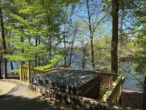 The hot tub is set in the woods and overlooks the lake.  Perfect for relaxing