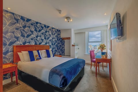 Sink into plush bedding with a bright coastal outlook.